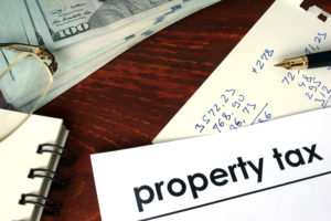 Property tax written on a paper. Financial concept