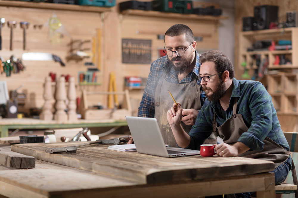 woodshop small business two men working on computer